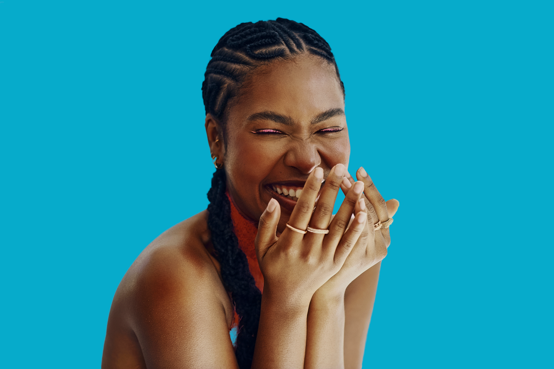 Woman laughing with clean cornrows and side braids